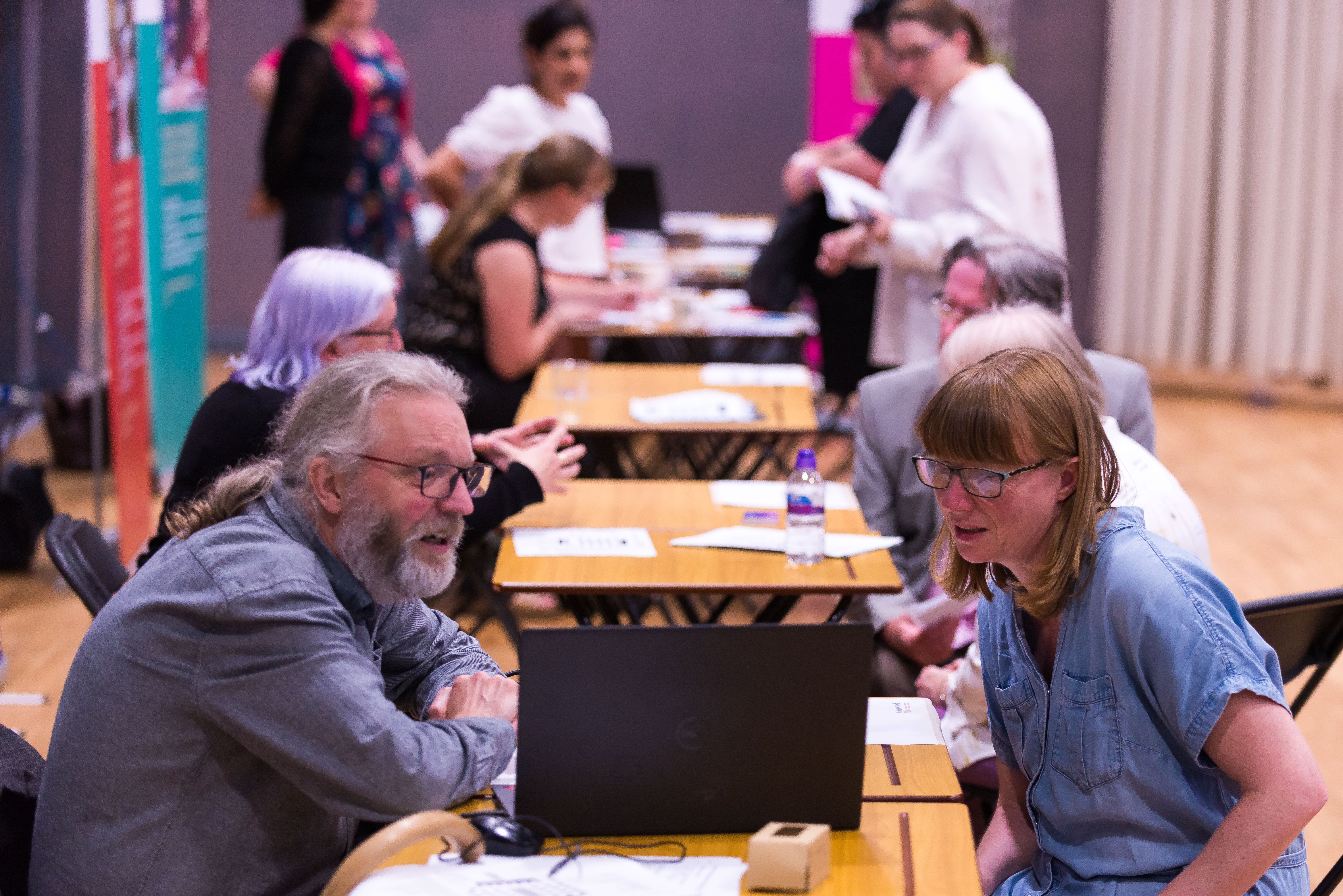 individuals having a conversation at a small table